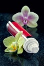 Bottle of face cream/lotion with orchid flowers Royalty Free Stock Photo