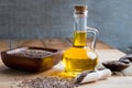 A bottle of flax seed oil, with flax seeds in the foreground Royalty Free Stock Photo