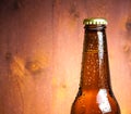 Bottle of fresh beer with drops on wood Royalty Free Stock Photo