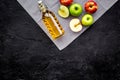 Bottle of fresh cider near autumn apples. Black background top view space for text Royalty Free Stock Photo