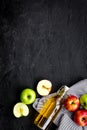 Bottle of fresh cider near autumn apples. Black background top view space for text Royalty Free Stock Photo