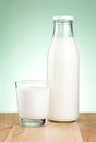 Bottle of fresh milk and glass is wooden table Royalty Free Stock Photo