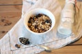 Bottle of fresh milk with Oat and whole wheat grains flake on wooden table. Homemade granola in a bowl and milk or Royalty Free Stock Photo