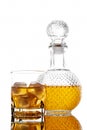 Bottle and glass with alcoholic drink with ice, on the rocks, whisky, rum, cognac, brandy, scottish, white background