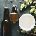 Bottle and Glass beer with Brewing ingredients. Hop flower with wheat. Top view. Copy space. Still life. Flat lay Royalty Free Stock Photo