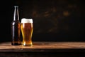 Bottle and glass of beer on a wooden table on a dark brown background Royalty Free Stock Photo