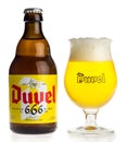 Bottle and glass of Belgian Duvel 666 Blonde beer isolated on white