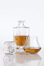 Bottle and glass of brandy on a white table Royalty Free Stock Photo