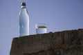 Bottle and glass with cold fresh water against the sky Royalty Free Stock Photo