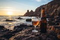 A bottle and a glass of fresh beer on rocky beach on sunny summer evening. Beer on a background of Irish nature. Drinking