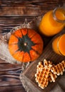 Bottle and Glass of fresh pumpkin juice with wafer and pumpkin o Royalty Free Stock Photo