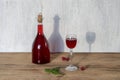 Bottle and glass of homemade raspberry liqueur