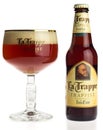 Bottle and glass of La Trappe Isid` or beer isolated on white