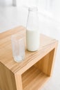 Bottle and glass of milk on wooden table