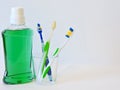 Bottle and glass of mouthwash on bath shelf with toothbrush. Dental oral hygiene concept. Set of oral care products Royalty Free Stock Photo