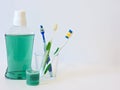 Bottle and glass of mouthwash on bath shelf with toothbrush. Dental oral hygiene concept. Set of oral care products Royalty Free Stock Photo