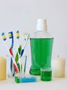 Bottle and glass of mouthwash on bath shelf with toothbrush. Dental oral hygiene concept. Set of oral care products Royalty Free Stock Photo