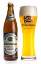 Bottle and glass of non alcoholic Weihenstephaner wheat beer isolated on white