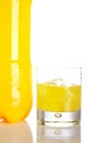 Bottle and glass of orange soda with droplets Royalty Free Stock Photo