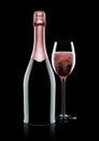 Bottle and glass of pink rose champagne on black Royalty Free Stock Photo