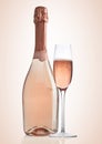 Bottle and glass of pink rose champagne on pink Royalty Free Stock Photo