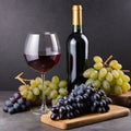 bottle and glass of red wine with bunch of grapes on wooden table. Royalty Free Stock Photo