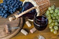 Bottle and glass with red wine, bunches of grapes and corkscrew Royalty Free Stock Photo