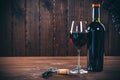 Bottle and glass of red wine, grape and cork Royalty Free Stock Photo