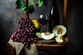 Bottle and glass of red wine, grape and cork on chair. Melon, piece of melon. Pink grape, pear. Still life of food. Dark Royalty Free Stock Photo