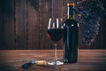 Bottle and glass of red wine, grape and cork Royalty Free Stock Photo