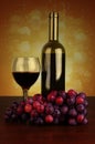 Bottle and glass of red wine with grapes