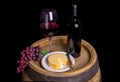 Bottle And Glass Of Red Wine With Grapes And Cheese On Barrel Royalty Free Stock Photo