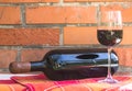 Bottle and glass of red wine near wall of orange bricks. loft st Royalty Free Stock Photo