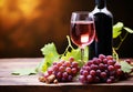 Bottle and glass of red wine next to a bunch of grapes with a blurred background Royalty Free Stock Photo