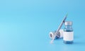 Bottle glass vaccine with syringe against a blue background Royalty Free Stock Photo