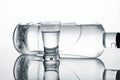 Bottle and glass of vodka lying isolated on white background Royalty Free Stock Photo