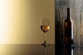 Bottle and glass of white wine on a black table Royalty Free Stock Photo