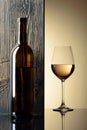 Bottle and glass of white wine on a black table Royalty Free Stock Photo