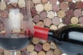 Bottle and glass of wine on a background of corks Royalty Free Stock Photo