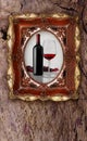 Bottle and glass wine in old picture frame on wood background Royalty Free Stock Photo