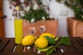 Bottle and glasses of fresh lemonade on table.