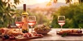 Bottle and glasses of pink rose wine with snack board on table on summer romantic evening.Macro.AI Generative Royalty Free Stock Photo