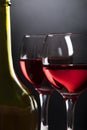 Bottle, glasses with red wine on black gradient Royalty Free Stock Photo