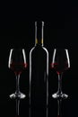 Bottle and glasses of red wine on dark background Royalty Free Stock Photo