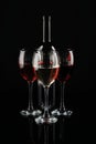 Bottle and glasses of red wine on dark background Royalty Free Stock Photo