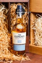 Bottle of the Glenlivet founders reserve on a wooden box background with straw