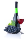 Bottle and goblet of red wine with grapes isolated Royalty Free Stock Photo