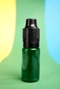 Bottle with green food coloring on bright background Royalty Free Stock Photo