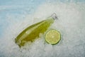 Bottle of green lime drink on crushed ice Royalty Free Stock Photo