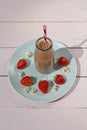 Bottle of healthy strawberry smoothie on the blue plate Royalty Free Stock Photo